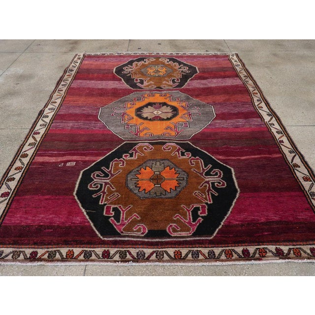 This piece features a wool pile of symmetric knots on a wool foundation. Smaller than most vintage Kars carpets, it boasts...