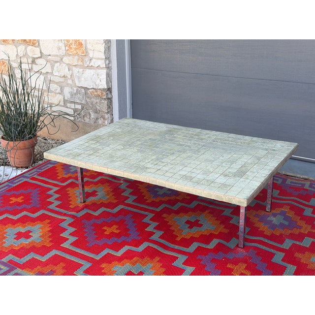 Gorgeous low profile coffee table featuring a tiled surface in soft, natural green tones that range from pale sage to...