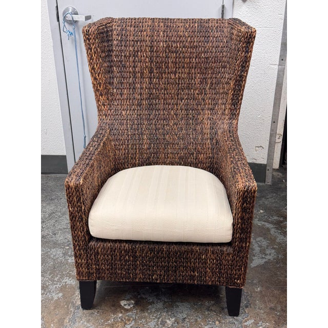 Design Plus Gallery presents a Woven Armchair from Crate & Barrel. A high back chair, gently curved arms, tapered black...