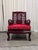 Vintage Chinese solid rosewood armchair with a hand-carved, pierced dragon medallion set into a key-fret lattice back,...