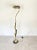 A large foliage floor lamp by Isabelle & Richard Faure. Composed of brass and metal hammered leaves with a black and white...