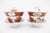 Beautiful pair of Japanese lidded tea bowls with saucers. Each in white porcelain, with hand painted floral and butterfly...