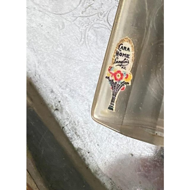 A beautifully preserved Art Deco vanity set by Cara Nome, featuring two metal cosmetic compacts with hinged closures and a...