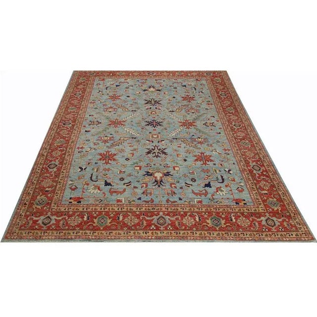 ACTUAL SIZE: 10’1″ x 13’10” PRIMARY COLOR: Blue / Rust AGE: New ORIGIN: Pakistan MATERIALS: Wool FOUNDATION: Cotton...
