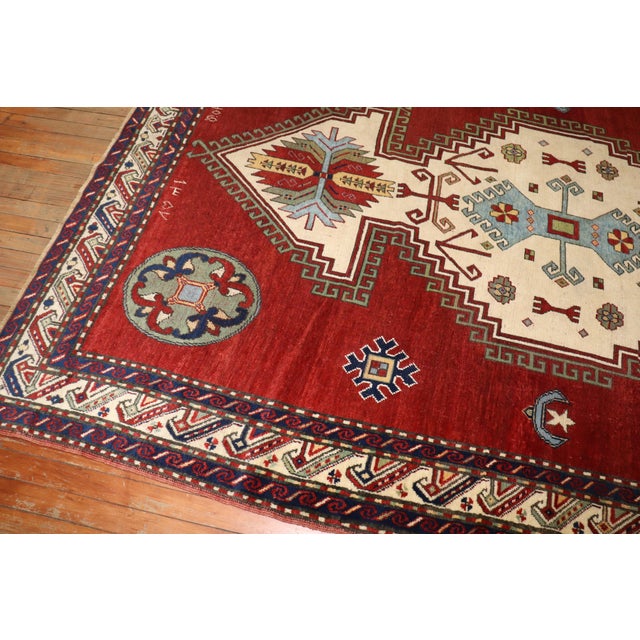 A geometric tribal-looking Armenian Kazak rug dated 1940. Some Armenian writing can be seen in the detailed shots as well....
