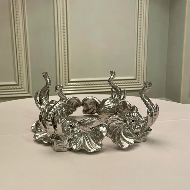 Collectible polished cast aluminum centerpiece bowl stand by Arthur Court features four detailed elephant heads with onyx...