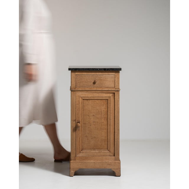 This 19th century Belgian side table from France is finished in brown, worked in oak. It is distinguished by its belgian...