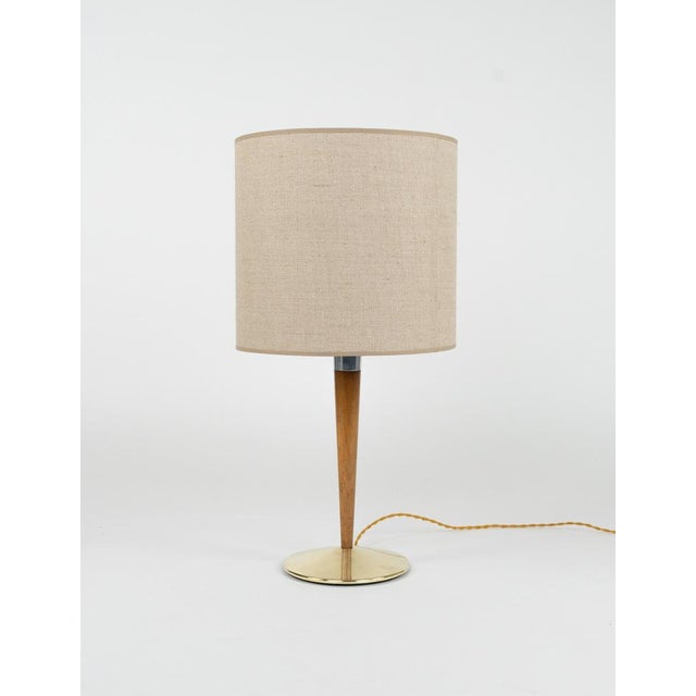 Midcentury beautiful table lamp mod. A/1 in brass, steel, wood and fabric by Sciolari. Made in Italy in the 1960s. The...