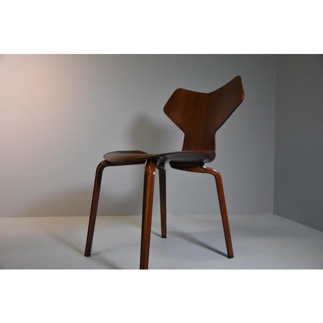 The chair is made entirely of wood and was designed by Danish designer Arne Jacobsen for the Fritz Hansen company in the...