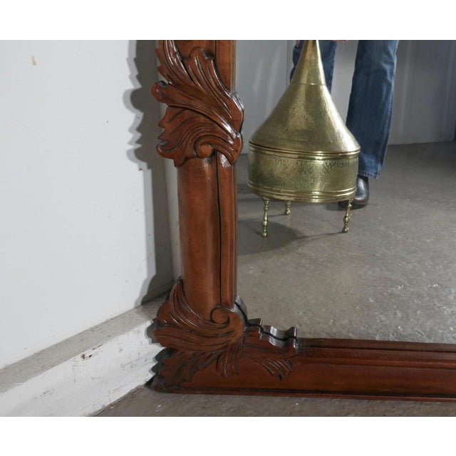 A superb large carved mahogany overmantel mirror. This is a striking piece it has a rectangular shape carved with entwined...