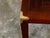 An English Campaign style walnut side table from the mid 20th century, with parquet style top, brass accents and straight...
