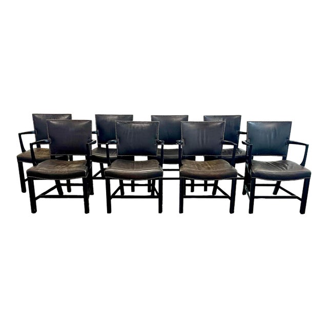 A set of eight dining chairs from luxury furniture maker Dessin Fournir. Hand-carved walnut frames feature an ebonized...