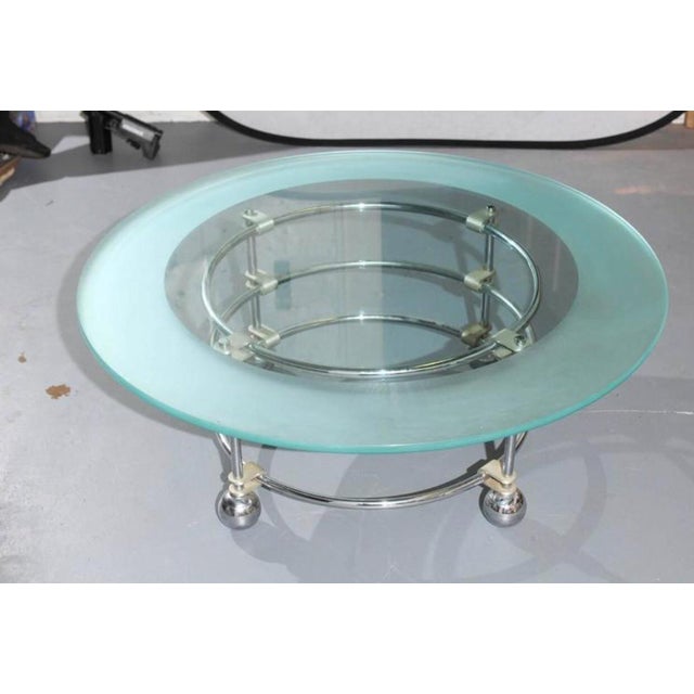 20th Century circular coffee table having a 1/2" thick glass top with acid etched border resting on a chrome base with...