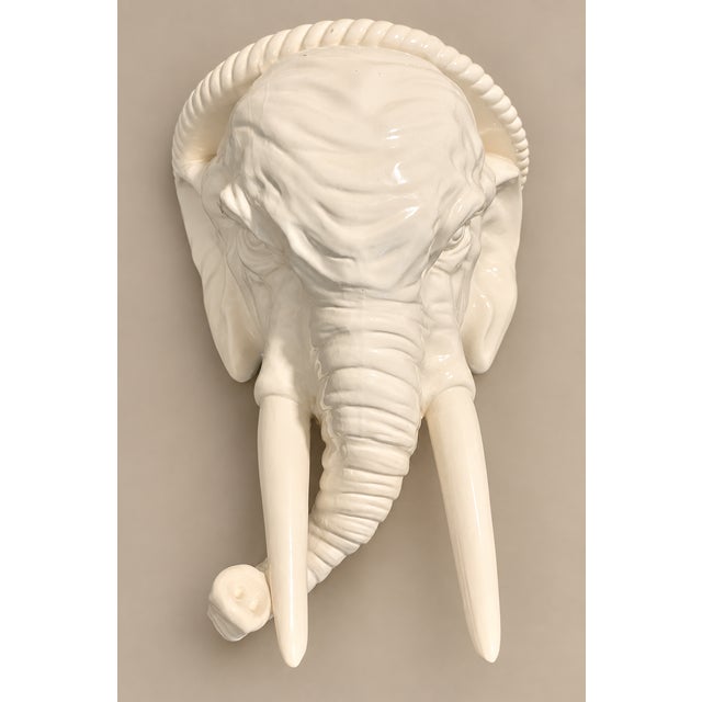 Large mid-century elephant head design in glazed white ceramic pottery. Flat platform top for display use. Hand painted....