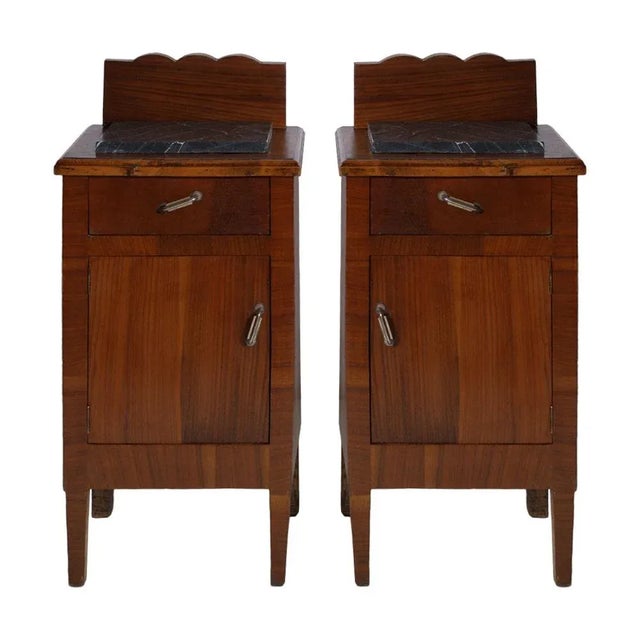 This early 20th century Art Nouveau Italian nightstand in solid walnut features a top in dark gray marble.