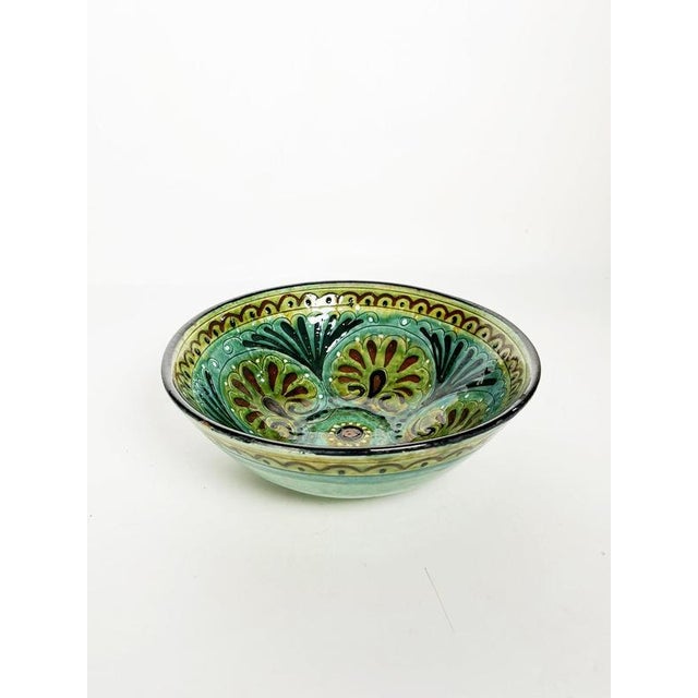 French Majolica dish dating from the early 20th century. The shallow circular form is richly decorated with hand-painted...