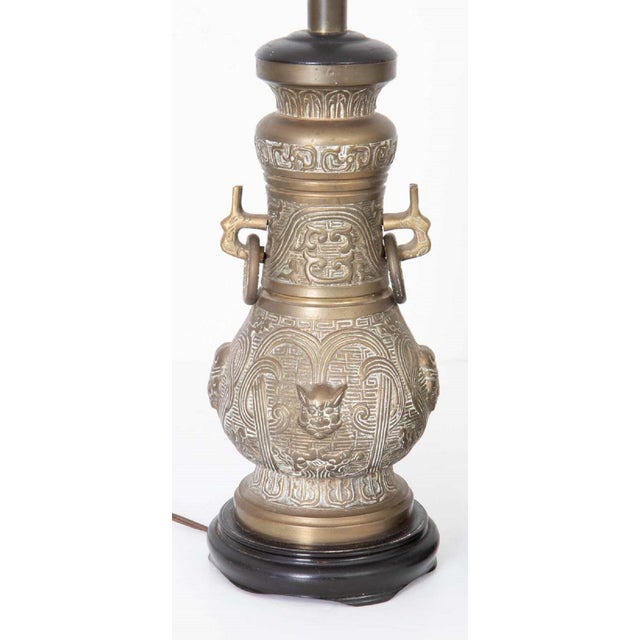 All original James Mont Asian style bronze lamps with original harps on wood bases. As found condition. Nicely made,...