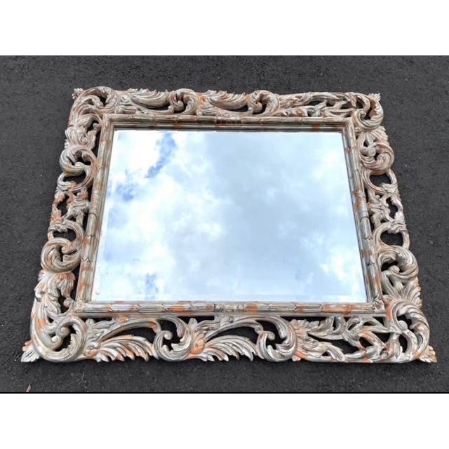 Impressive oversized Baroque-style wall mirror featuring an elaborate openwork frame with scrolling acanthus leaf carvings...