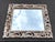 Impressive oversized Baroque-style wall mirror featuring an elaborate openwork frame with scrolling acanthus leaf carvings...