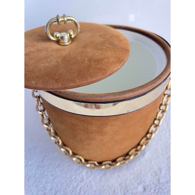 This Gorges Briard Camel Suede Ice Bucket in Brown with a Gold Tone Chain Handle is a stylish and unique addition to any...