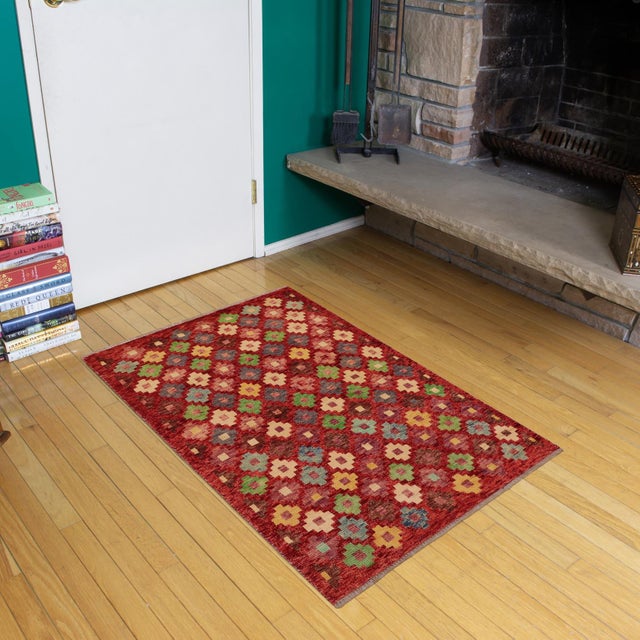 This stunning hand-knotted Afghan Balouchi rug is a captivating addition to any decor. Crafted by skilled artisans, it...