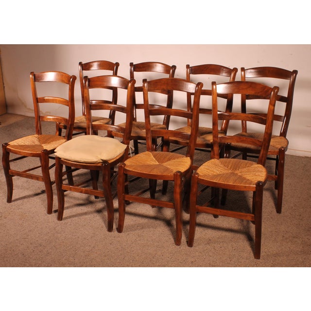 A delightful set of eight cherrywood straw-seated chairs. Beautiful French craftsmanship in cherrywood, which we have...