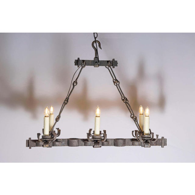 This 20th-century French wrought iron chandelier exemplifies rustic elegance with its sturdy construction and artisanal...
