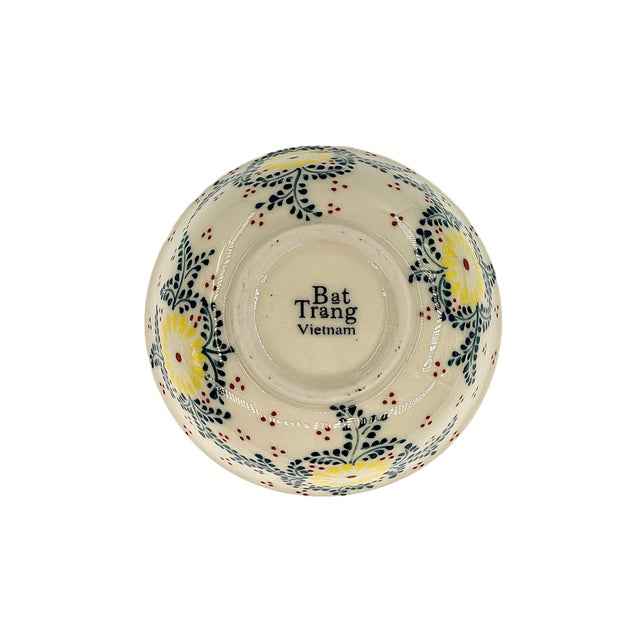 A cheerful set of six Bat Trang Vietnamese ceramic bowls, featuring a fresh floral design in sunny yellow, deep blue-...