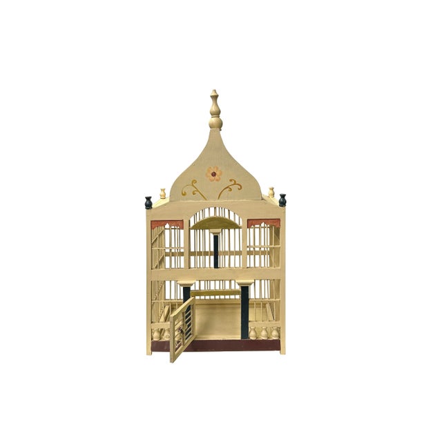 Presenting a meticulously handcrafted wooden bird cage, a true testament to traditional artistry and architectural charm....