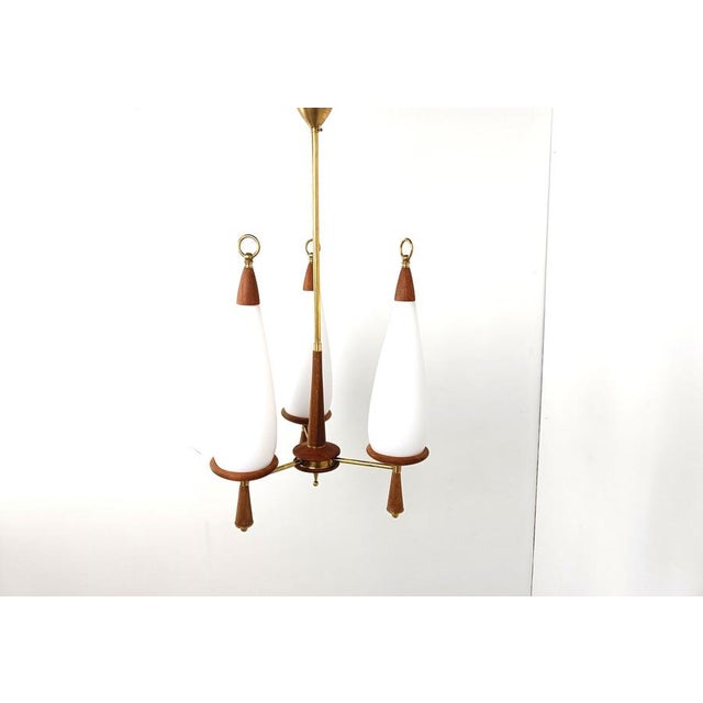 Mid century scandinavian chandelier made of teak with teardrop shaped milk glass shades. The teak chandelier is in perfect...