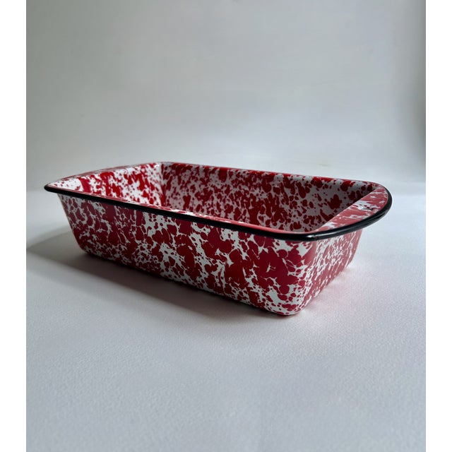 Vintage Black Rim Bright Red and White Splatter Enamelware Loaf Pan. Featuring a lipped Black rimmed, deep, rectangular...