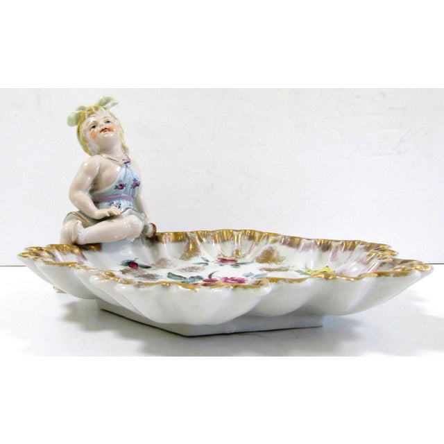The Antique German Meissen Porcelain Candy Dish with Bathing Woman Von Schierholz is a rare and exquisite piece of art...