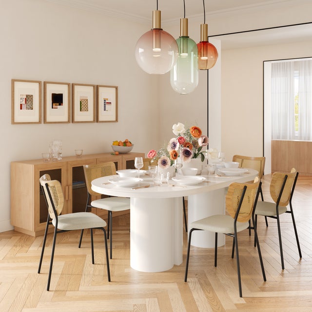 The Elora Lacquer Oval Dining Table is a stunning centerpiece for modern dining spaces, featuring a sleek lacquer finish...