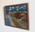 WWII narrative battle scene folk art painting, signed Gilbert W. Schuett. Artwork is 16"x20", in glass frame measuring...