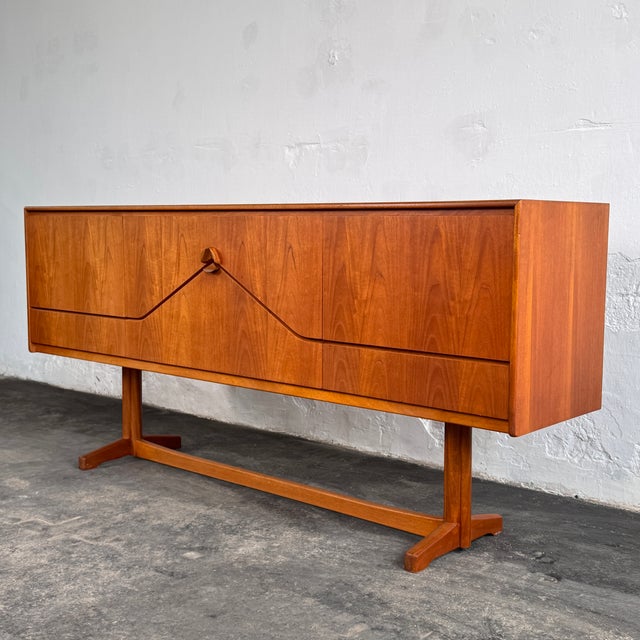 This sideboard is from the iconic "envelope" range by mcintosh of kirkcaldy, one of scotland's most celebrated mid-century...