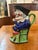 This antique 19th-century French Majolica Toby jug features the classic character of Mr. Punch, seated on a green chair....