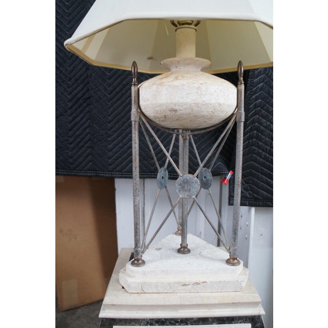 Late 20th Century Neoclassical Directoire Style Table Lamp. Features a round travertine urn shaped center supported by a...