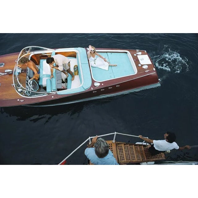 Monte Carlo 1975 by Slim Aarons Slim Aarons Limited Estate Edition Friends board a riva boat in Monte Carlo, Monaco, 1975....
