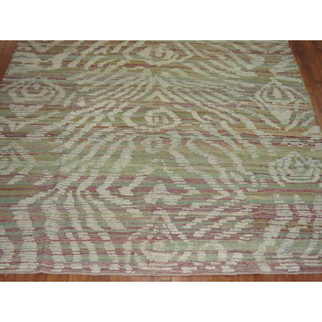 A one of a kind flat-weave carpet with a piled modern designed derived from old hand-spun wool used to make vintage...
