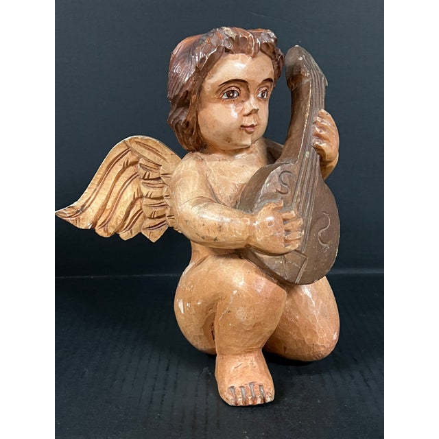ITEM NAME: Vintage Hand Carved Wooden Cherub Angel Playing a Mandolin Sculpture ORIGIN: Philippines AGES: Late 20th...