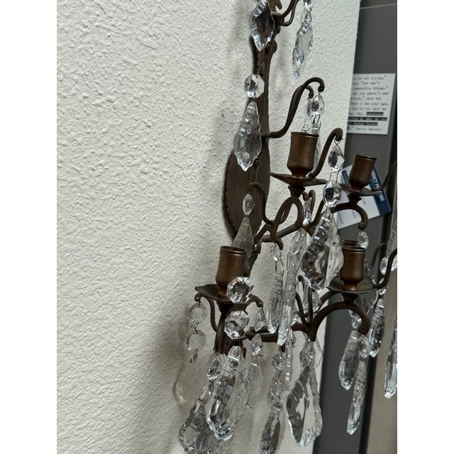 A beautiful pair of French Louis XV bronze and crystal candle sconces.