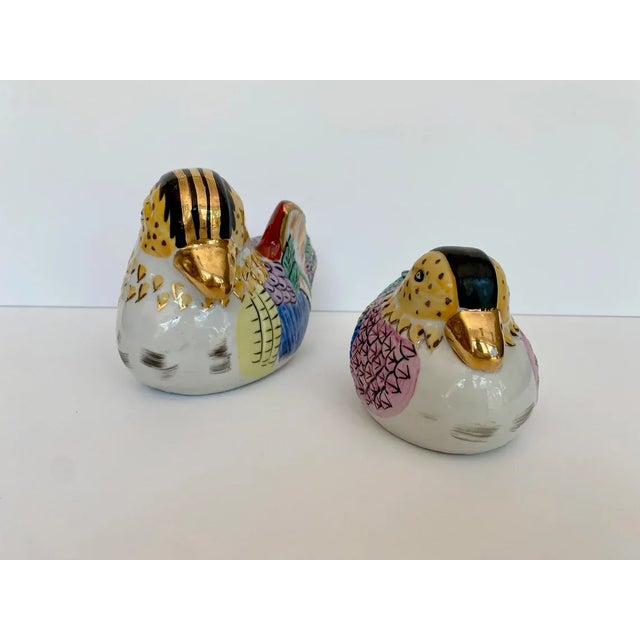 Lovely pair of hand painted, ceramic birds or ducks. Beautiful pastel colors - pinks, purples, aqua, light blue with gold...