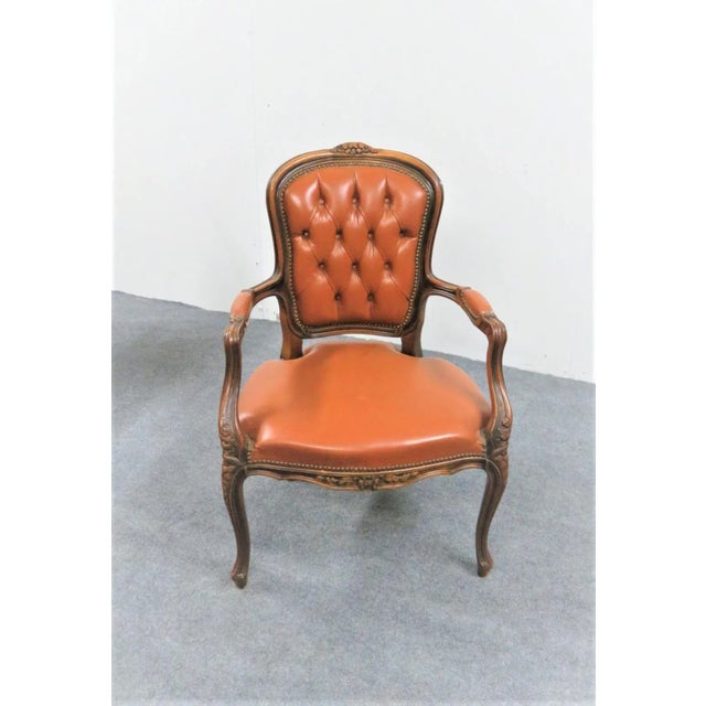 French Louis XV style chair, hand carved walnut frame , leather tufted upholstery, brass anil head trim , Made by Chateau...