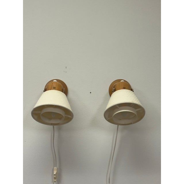 Great pair of wall lights with oak construction and fabric shades. Very good condition. 3.5" plate, attaches with two screws.