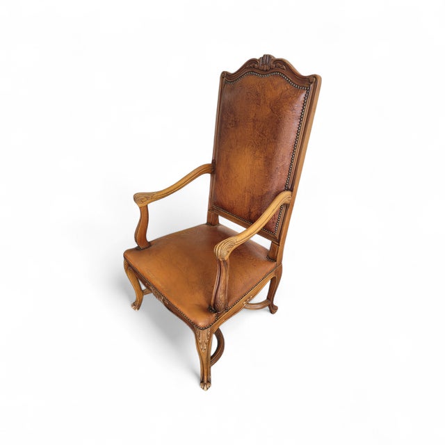 A beautifully proportioned french armchair in the louis xv taste, dating to the 20th century and upholstered in richly...