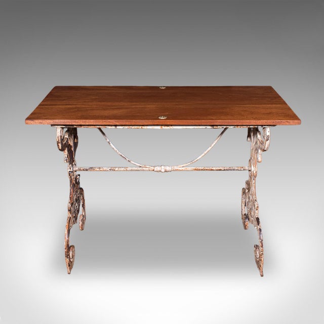 This is an antique orangery glasshouse table. An English, mahogany and cast iron garden flower or display table, dating to...