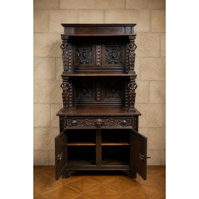 An important two-part renaissance-style buffet, crafted from oak and featuring a richly sculpted decoration in high...