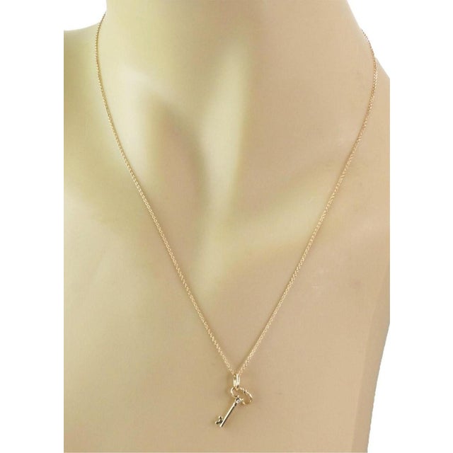 This authentic Tiffany & Co. pendant necklace is crafted in solid 18k yellow gold with a polished finish and features a...