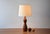 Scandinavian Mid-century table lamp made from turned teak and in the style of Finn Juhl. Made circa 1960s. The teak has a...