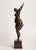 "Fall" — from the Seasons series A contemporary figurative bronze of a dancing woman, one arm flung high and one leg...